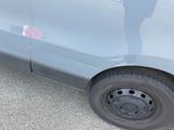 a person standing next to a car with a sticker on it