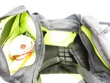 a black and green bag with some items inside of it