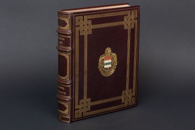 an old book sitting on top of a table next to a gray wall