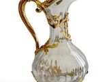 un pichet en verre orné d'un motif doré