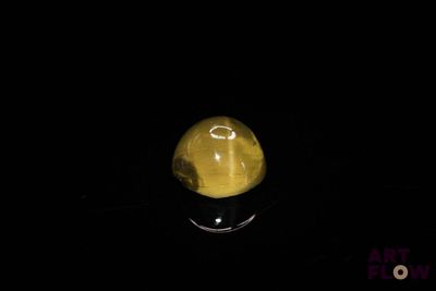 an image of a yellow stone in the dark