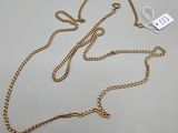a gold chain necklace with a tag attached to it