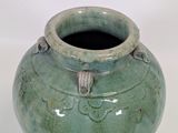a green vase with a handle on a white background
