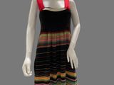a mannequin wearing a multicolored dress on a gray background