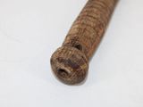 a wooden pipe with a hole in it on a white surface