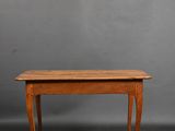 a wooden table with a curved legs and a wooden top