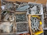 many different types of screws and nails in a box