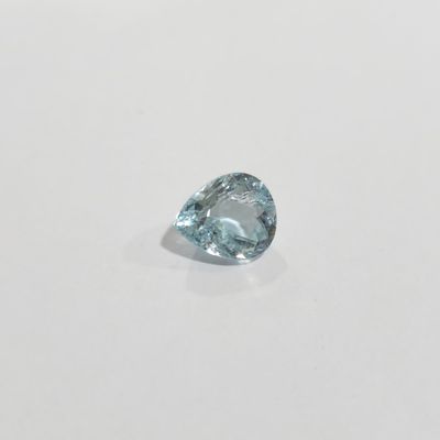 a close up of a blue diamond on a white surface