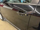 a close up of a car door handle with a sticker on it