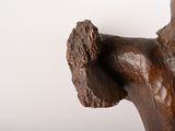 a wooden statue of a man with his arm raised