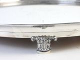a silver plate with a flower decoration on it