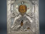 an image of a silver metal plaque with a picture of a man