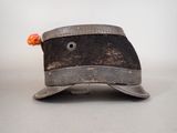 an old black hat with a pom pom on top of it