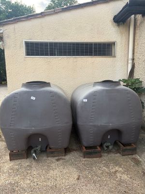 two large tanks sitting next to each other on the side of a building