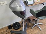 a hair dryer sitting on top of a chair next to a desk