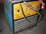 an image of a welding machine sitting in a garage