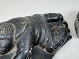 a statue of a man laying down next to a statue of a woman