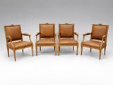 a set of four chairs with leather upholstered back and arms