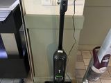 un aspirateur posé par terre, à côté du sol