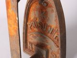 an old rusted iron door handle with a rusting sign on it