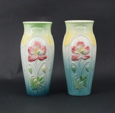 two vases with flowers painted on them on a black background