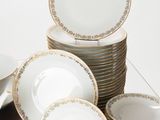 a lot of plates and bowls sitting on a table
