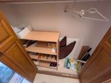 un placard contenant une étagère et une chaise