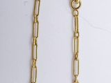 gold plated chain necklace with blue glass beads on a white background