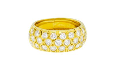 a yellow gold ring with diamonds on a white background