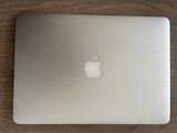 un ordinateur portable Apple blanc posé sur une table en bois