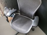 a gray office chair with a bottle of water on it