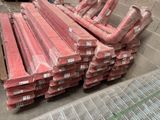 a lot of red pipes that are stacked on top of each other