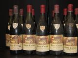 several bottles of wine are lined up on a table