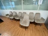 a row of chairs in a waiting room with a sign on the wall