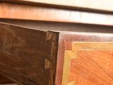 a close up of a wooden desk with a drawer on it