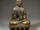 an image of a bronze statue of a buddha sitting on a lotus