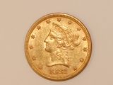 a close up of a gold coin with a woman ' s head on it