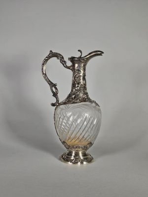 un vase ancien en verre plaqué argent, muni d'une anse, sur fond blanc
