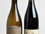 two bottles of wine that are sitting on a table