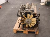 a small engine sitting on a pallet on the ground