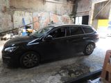 a black car that is parked in a garage