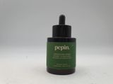 a close up of a bottle of peppermin oil on a white surface