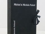 a black book with a bow on top of it sitting on a table