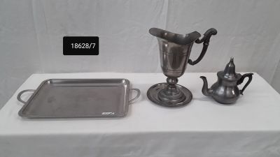 a silver tray with a silver teapot and a silver tray with a silver teapot and a silver tray with a silver teapot on it