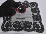 a pair of red sunglasses and a black purse on a table