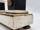 pair of black and white marble clock stands with gold accents