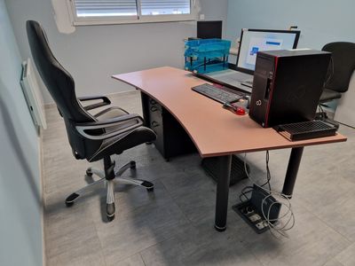 a desk with a computer and a laptop on it