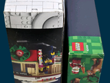 two boxes of legos sitting next to each other on a table