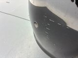a close up of a car ' s front bumper with holes in it