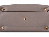 a close up of a gray purse on a white background